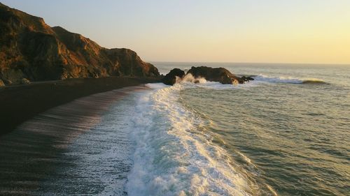 Scenic view of sea against clear sky during sunset