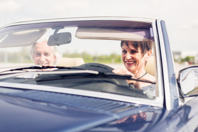 Portrait of smiling man in car