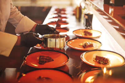 Midsection of man having food at table
