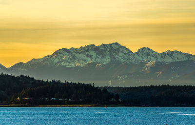 A sunset with the olympic mountains across the puget sound.