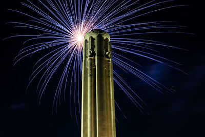 Low angle view of firework display at night