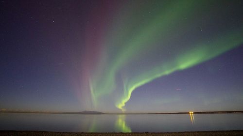 Scenic view of lake against sky at night