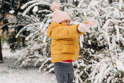 Toddler girl happy with snow day in winter. playing outside on christmas holiday. high quality photo