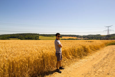 Full length of man standing on land against clear sky