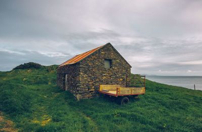 House on shore against sky