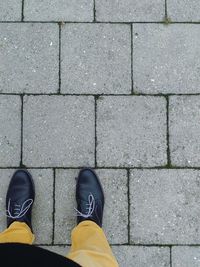 Low section of man standing on footpath