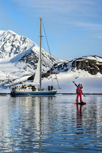 Woman paddleboarding in jan mayen on ski trip