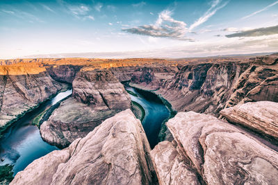 Scenic view of rocks against sky during sunset