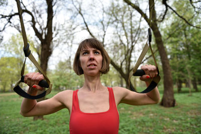 Mid adult woman exercising at public park