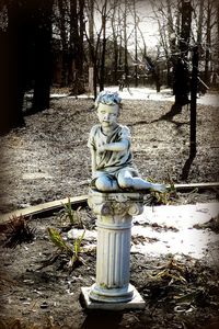 Statue in park during winter