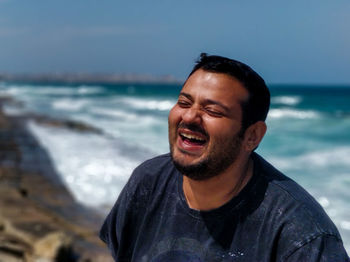 Portrait of smiling young man on beach