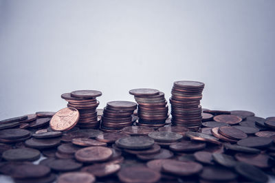 Stack of coins on floor against white background