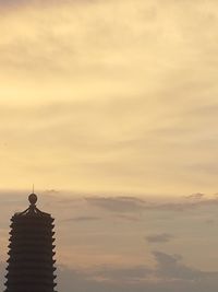 Silhouette building against sky during sunset