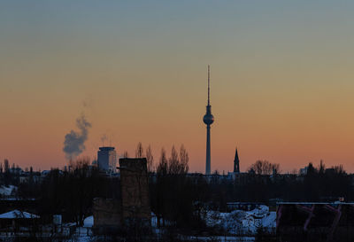 Fernsehturm tower against sky during sunset in city