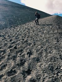 Full length of man walking on mountain against sky