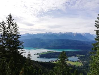 Scenic view of lake and mountains against sky