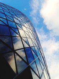 Low angle view of modern building against blue sky