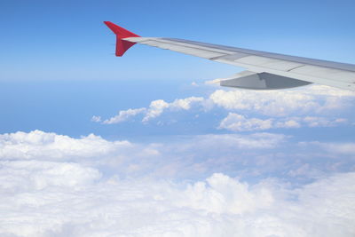 Aircraft wing flying in cloudy sky