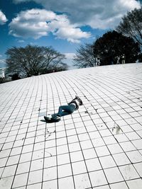 High angle view of boy lying on floor against sky