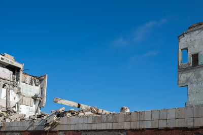 Low angle view of building against blue sky