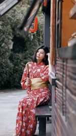 Young woman sitting outdoors