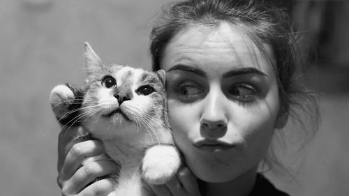 Close-up portrait of woman with cat