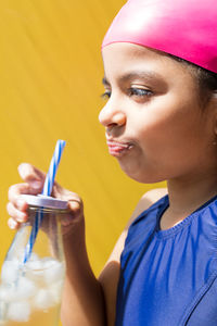 Close-up of young woman drinking glass