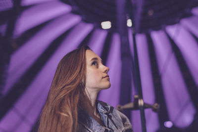 Low angle view of young woman looking away