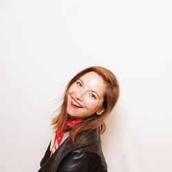 Portrait of smiling young woman against white background