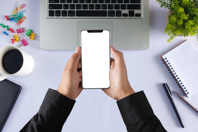 Directly above view of man using laptop on table