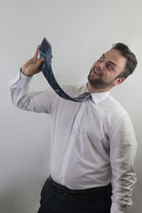 Young man photographing against white background