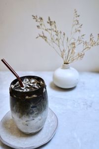 Close-up of cocktail in glass vase on table