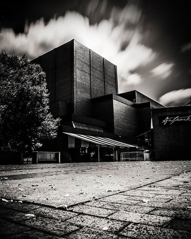 architecture, built structure, building exterior, sky, cloud - sky, cloudy, building, cloud, city, outdoors, day, street, no people, low angle view, weather, tree, the way forward, road, overcast, dusk