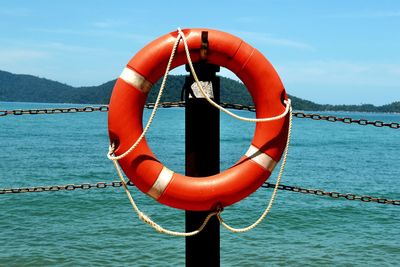 Close-up of rope on sea against blue sky