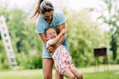 Happy mother with baby girl outdoors