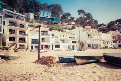 Boats moored at beach against sky