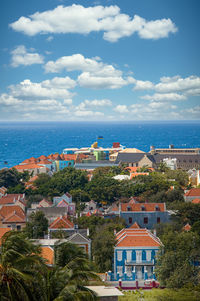 High angle view of townscape by sea against sky