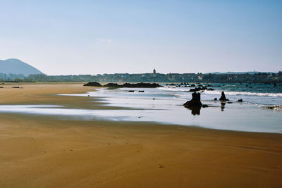 People on beach against sky