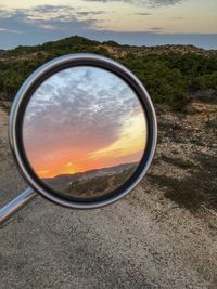 Close-up of sunglasses on side-view mirror