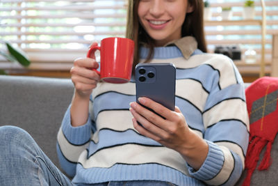 Midsection of woman using phone