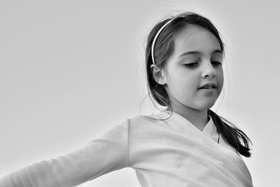 Portrait of cute girl against white background