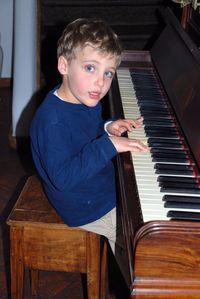 Boy playing piano at home