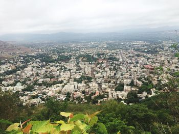 Cityscape against cloudy sky