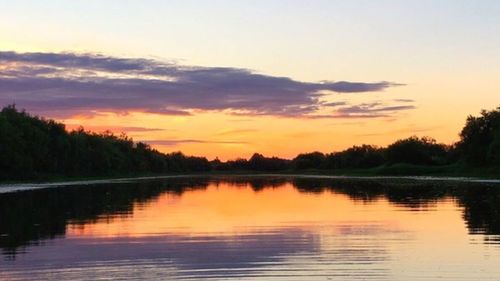 Scenic view of calm lake at sunset