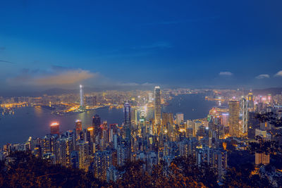 High angle view of illuminated buildings against sky at night