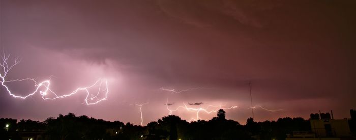 Panoramic view of lightning in sky at night