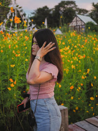 Full length of woman standing on flowering plants