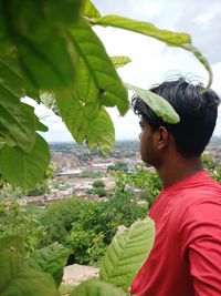 Portrait of young man looking at plants