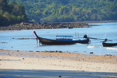 Boats moored on sea shore