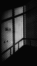 Full frame shot of silhouette fence against window
